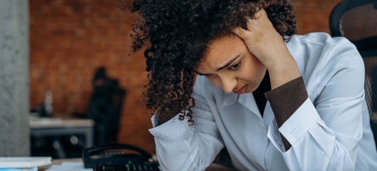 A woman holding her head