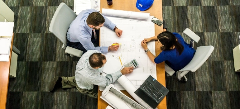 three people having a meeting