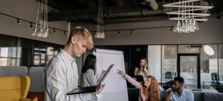 a team of young people working on a project before they prepare your employees for a cross country commercial relocation