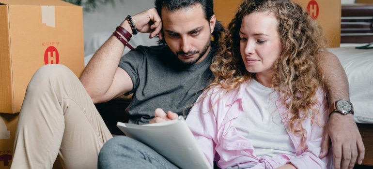 A man and a woman looking at documents