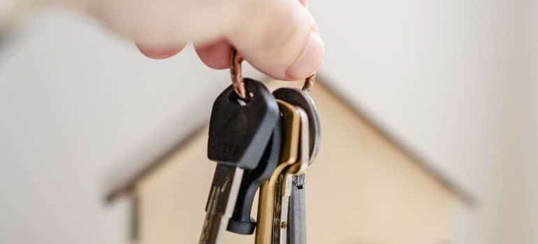 a person holding keys for a new home