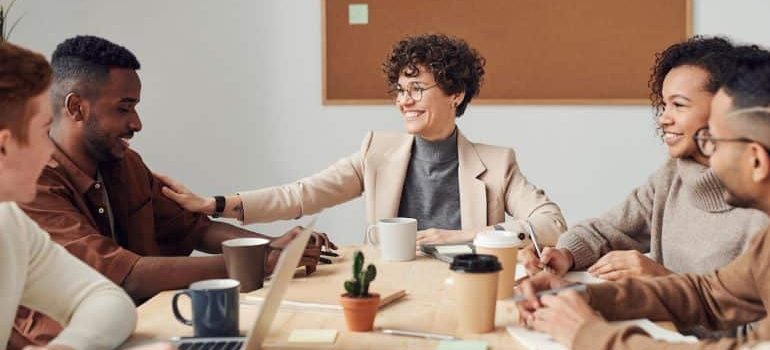 collegues at the meeting in an office talking to each other