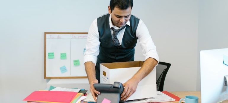 a man packing his desk in the office