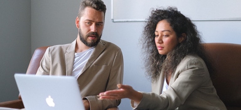 two people with laptop