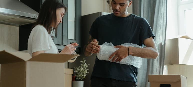 A man and a woman packing their belongings