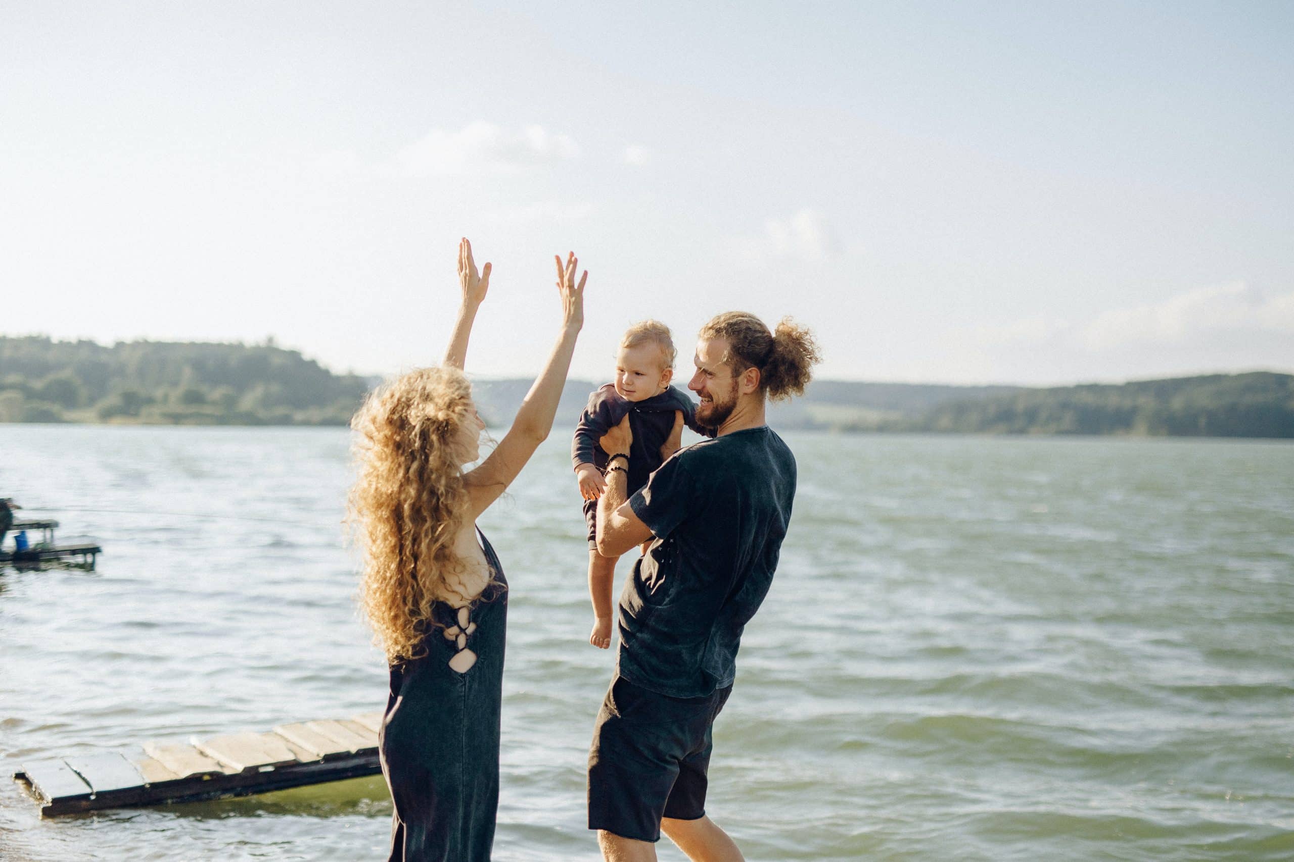 a couple with a child near the water taking about move from Boca Raton to Miami