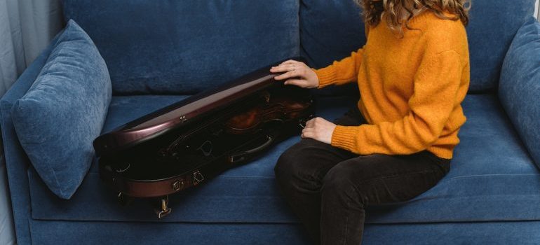 Woman preparing violin for storage