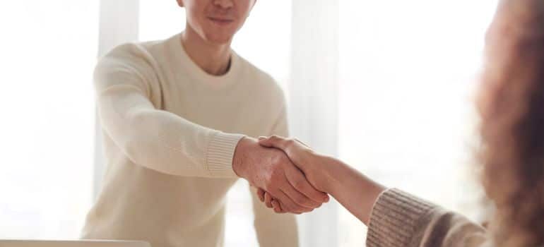 a man and a woman shaking hands in an office