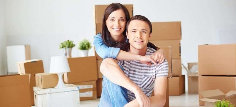 a couple unpacking in order to move to Fort Lauderdale with kids