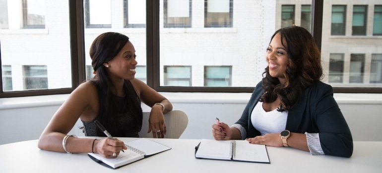 two woman talking in the office in one of the best places to live in Palm Beach County