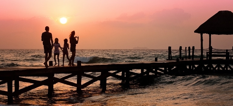 family enjoying the sunset thinking about Living in Florida vs California