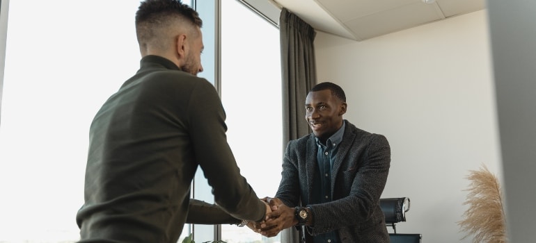 two man shaking hands in one of the best places in Florida for singles