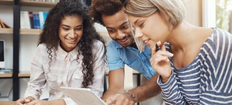 three people trying to spot a fake realtor on the Internet