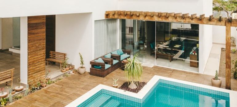 contemporary style house with a pool in one of the best neighborhoods in Boca Raton for families