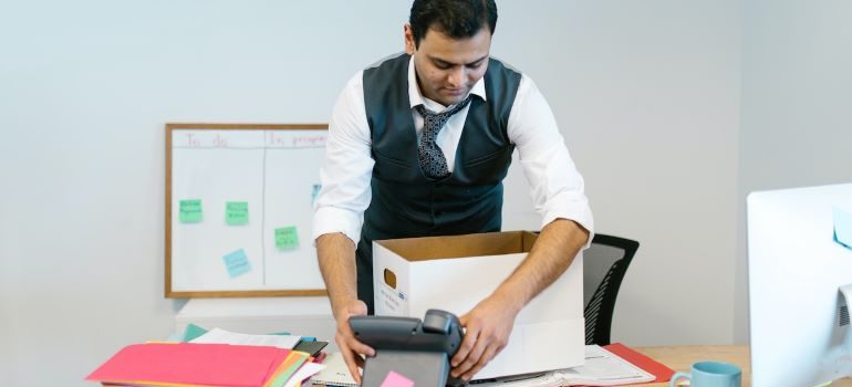 a man packing things in his office