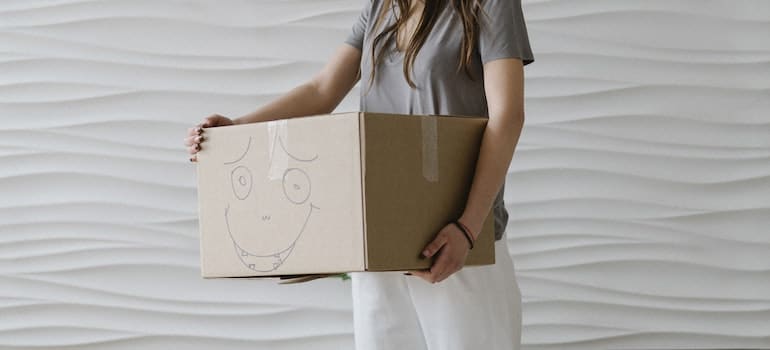 girl holding a box