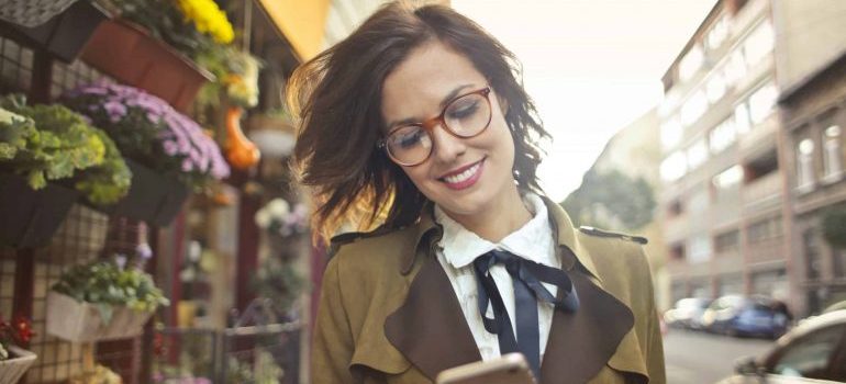 A happy woman looking at her phone