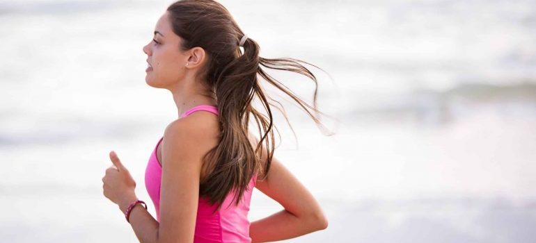 A runner jogging at the beach in Timberwalk, one of the best neighborhoods for young professionals in Boca Raton