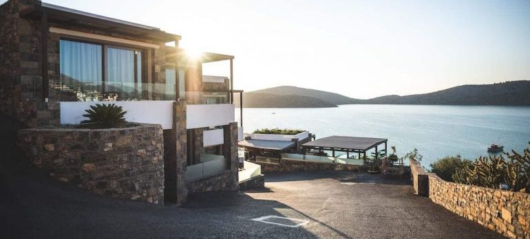 A view of a beautiful, big home by the sea