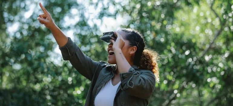 A woman with binoculars looking around