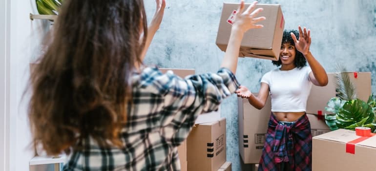 two girls' with moving boxes