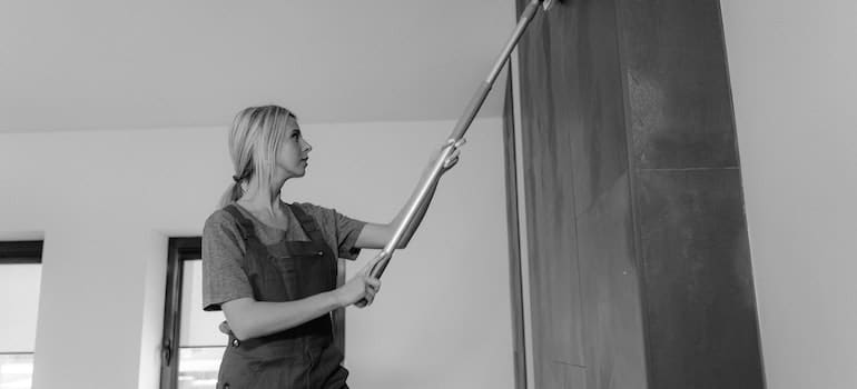 woman cleaning a wall