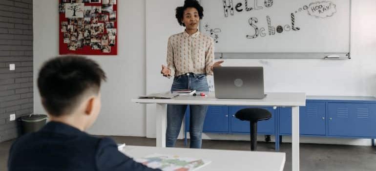 a teacher standing in front of the class