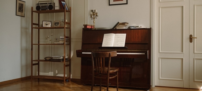 A wooden chair near the piano