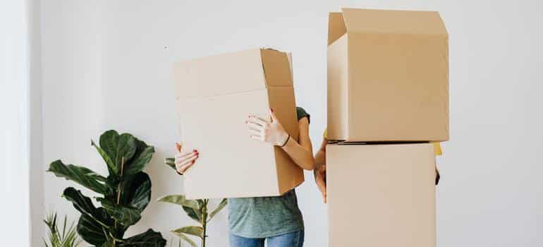 two people holding boxes