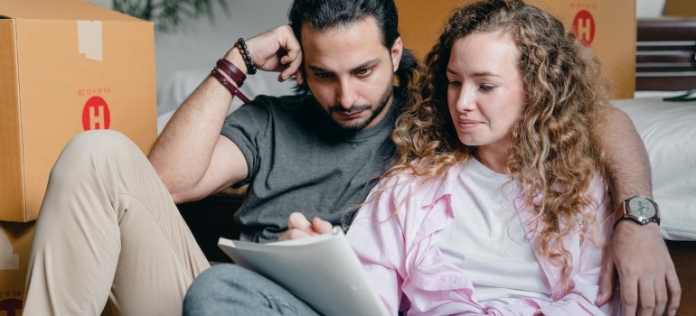 Couple planning wondering how to calculate and alleviate Miami moving costs