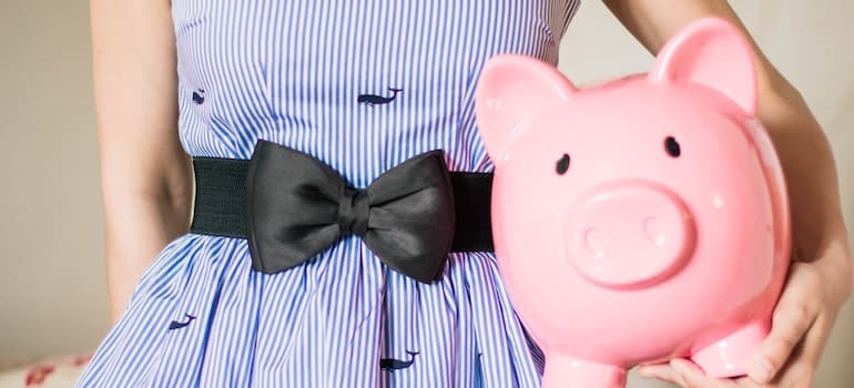 Woman holding a piggy bank