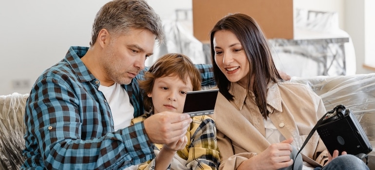 A happy family sitting on a couch after using services that will make your Florida relocation a breeze