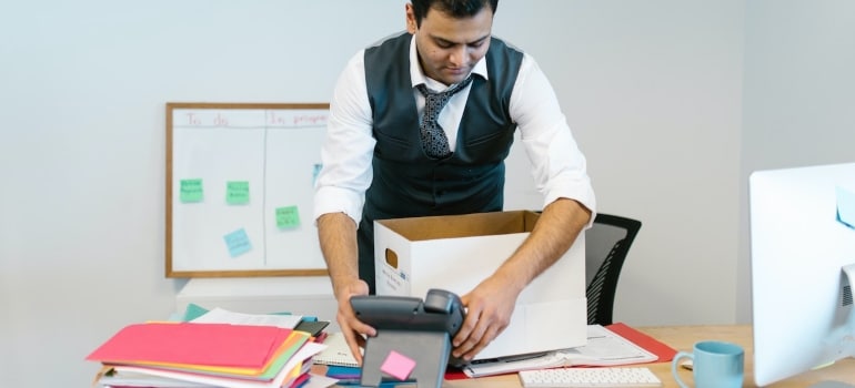 An employee packing his desk