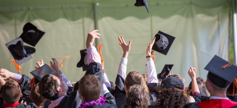 students throwing their graduation caps