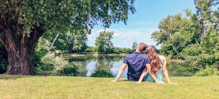 A couple sits in a park after moving to one of the Florida towns for first time home buyers.