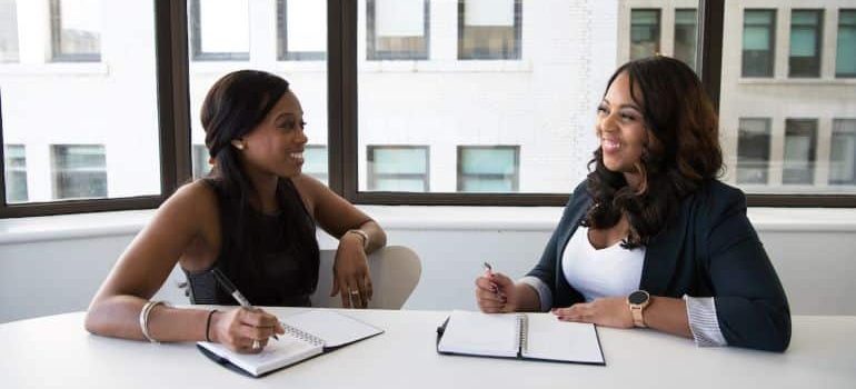 two coworkers talking in the office