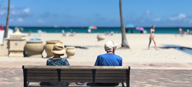 A couple in Miami on a bench.