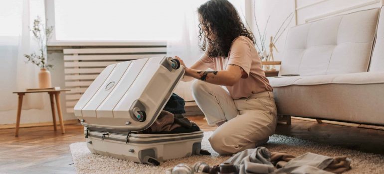 A young woman packing her luggage