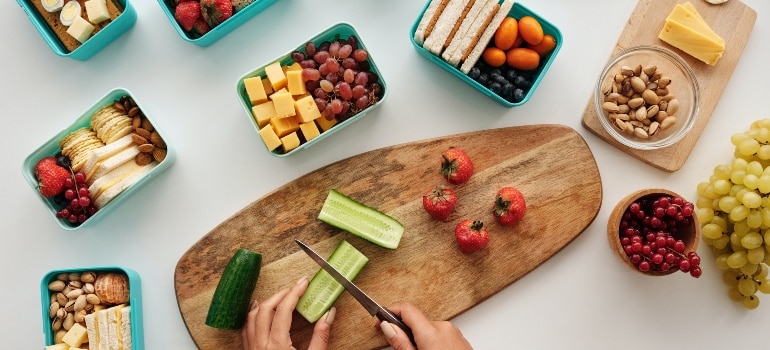 A person making lunchboxes before they relocate from Hallandale Beach to Miami.