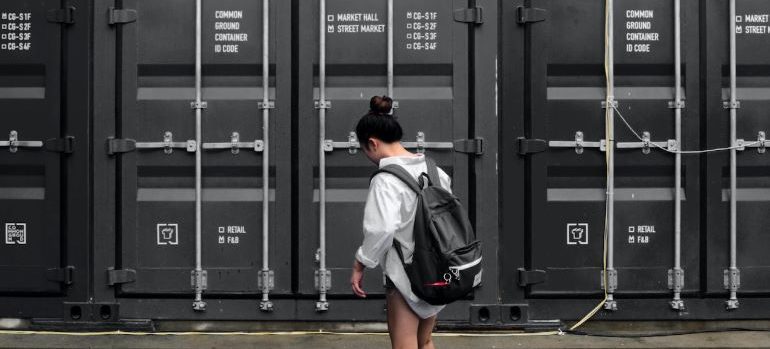 A woman in front of a storage container.