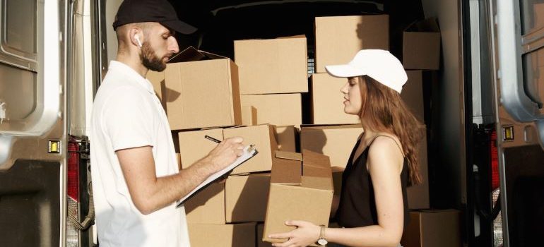 Two movers loading the truck.