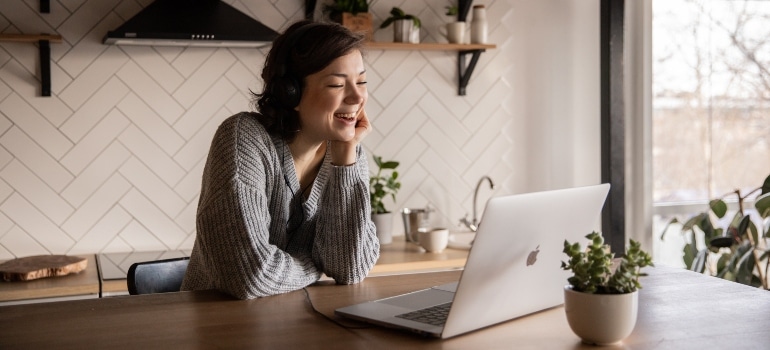 Woman looking at her laptop finding your movers online.