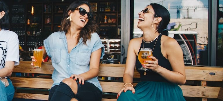 A girl in a bar making friends after moving to Miami.