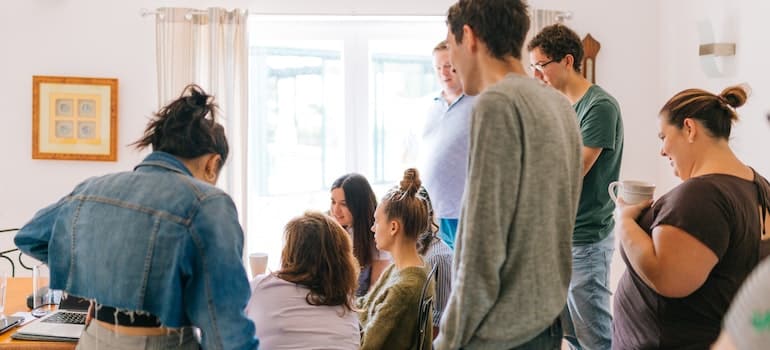 A group of people in a room discussing business solutions.