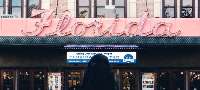 A person standing in front of Florida theatre thinking about why military families love living in Florida.