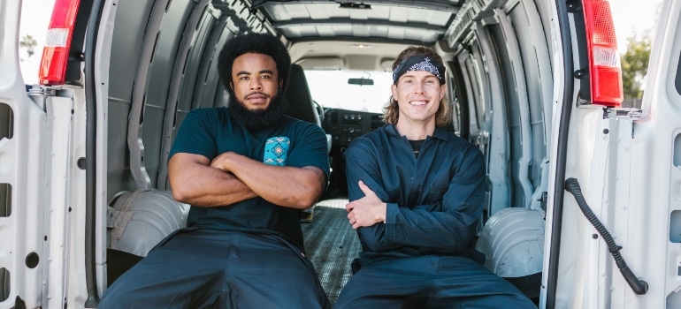 Moving professionals sitting in a truck.