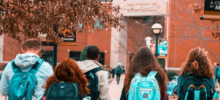 College students wearing backpacks on their way to New York education system and local universities.