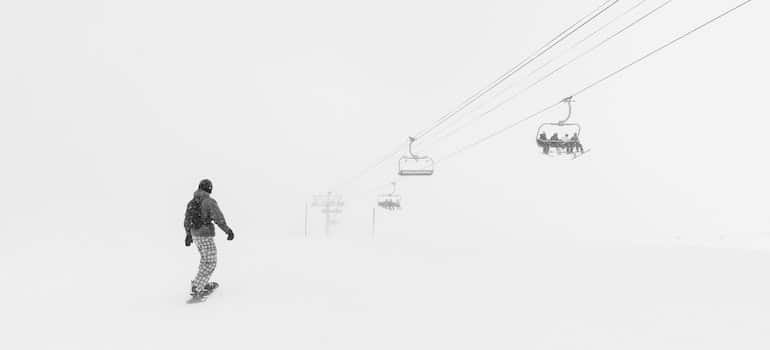 A man who's skiing going up a snowy hill.