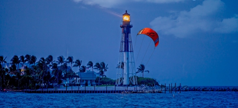 A white and black lighthouse by the coast