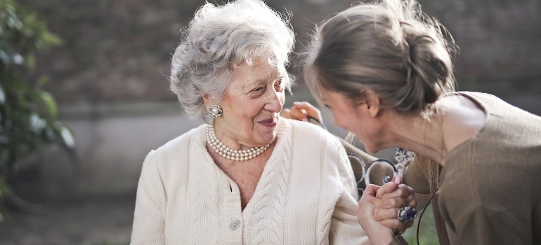 A mother and daughter talking about decluttering tips for seniors